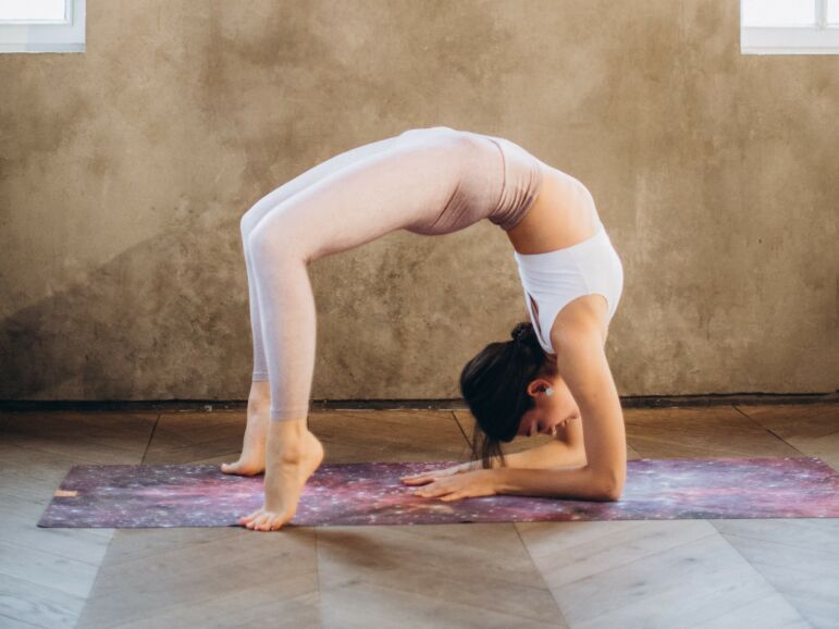 Woman performing a backbend, imitating a retroverted uterus