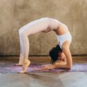 Woman performing a backbend, imitating a retroverted uterus