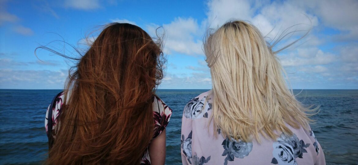 Two women sitting together confiding in one another