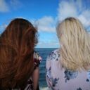 Two women sitting together confiding in one another